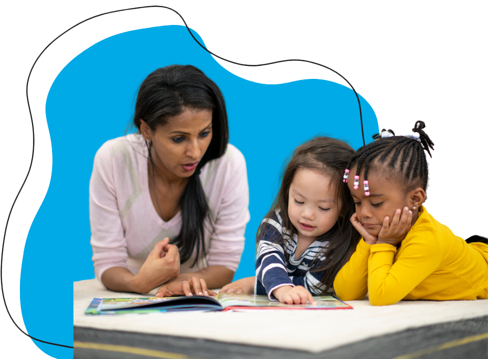 a woman and two young children reading a book